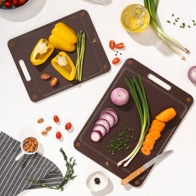 One small and one large brown kai wood fibre chopping board with vegetables
