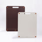 Two large bykurahome cutting boards, one brown and one beige